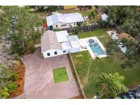 Aerial view showing home, pool, and large paved driveway at 2826 Marlette St, Sarasota, FL 34231