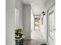 Bright hallway with tiled floors and access to outdoor patio at 404 Cerromar N Cir # 108, Venice, FL 34293