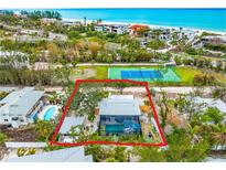 Aerial view showing house, pool, and tennis court nearby at 531 Edlee Ln, Longboat Key, FL 34228