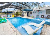 Large screened pool area with spa and lounge chairs at 531 Edlee Ln, Longboat Key, FL 34228