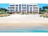 Modern beachfront building with expansive windows and private beach access at 70 Avenida Veneccia # 202, Sarasota, FL 34242