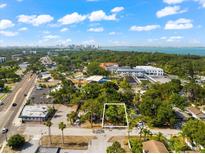 Aerial view of a residential lot, surrounded by lush trees and near to the water at 966 32Nd St, Sarasota, FL 34234