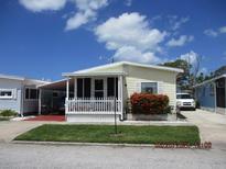 Yellow single-wide mobile home with carport and small front yard at 10315 Cortez W Rd # 6Wp, Bradenton, FL 34210