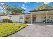 Single story home with carport and well-maintained lawn at 3530 Tree Line Dr # 4, Sarasota, FL 34231