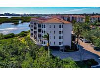 Luxury condo building with water views and a private parking area at 5450 Eagles Point Cir # 301, Sarasota, FL 34231