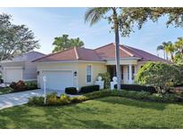 Single-story home with attached garage and well-manicured lawn at 7220 Kensington Ct, University Park, FL 34201