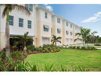 Row of modern townhouses with attached garages and landscaped lawns at 7366 Marathon Dr, Seminole, FL 33777