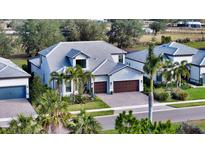 Luxury home community with lake views; multiple homes visible from above at 7872 Mainsail Ln, Sarasota, FL 34240