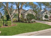 Single-story home with stone accents, lush landscaping, and a paved driveway at 12204 Thornhill Ct, Lakewood Ranch, FL 34202