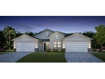 Two-story house with a two-car garage and landscaped yard at 18725 Dayspring Pl, Venice, FL 34293