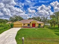 House exterior with a large front yard and driveway at 2534 Stagnaro Rd, North Port, FL 34287