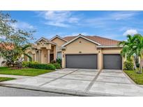 Beautiful two-story home with a three-car garage and manicured lawn at 4917 Sabal Lake Cir, Sarasota, FL 34238