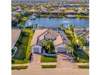 Luxury waterfront home with private dock and two-car garage; beautiful landscaping at 5607 Tidewater Preserve Blvd, Bradenton, FL 34208