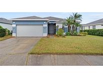 Single-story home with attached garage, well-maintained lawn, and landscaping at 6257 Weymouth Dr, Sarasota, FL 34238