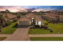 Attractive single-story home with brick paver driveway and landscaped lawn at 11467 Conch Ct, Venice, FL 34292