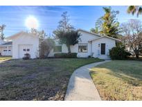White single-story house with attached garage and landscaped yard at 116 23Rd W St, Bradenton, FL 34205
