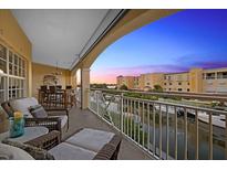 Relaxing balcony overlooking waterfront with comfortable seating at 14041 Bellagio Way # 315, Osprey, FL 34229
