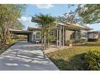 Mid-century modern home with carport and screened porch at 349 Scott Ave, Sarasota, FL 34243