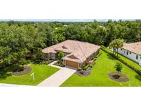 Single-story home with tile roof, driveway and landscaped lawn at 3861 Royal Hammock Blvd, Sarasota, FL 34240