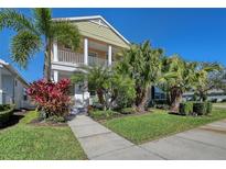 Two-story house with front porch, landscaping, and walkway at 4755 Woodbrook Dr, Sarasota, FL 34243