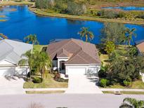 Single-story home with a three-car garage, situated on a lakefront lot at 4831 Boston Common Gln, Bradenton, FL 34211