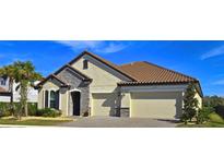 Two-story house with a two-car garage and stone accents at 7228 Great Egret Blvd, Sarasota, FL 34241