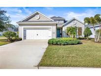 Single-story home with white garage door and landscaped lawn at 7521 Ridgelake Cir, Bradenton, FL 34203