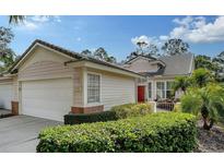 Two-car garage, attractive landscaping, and a charming front entrance at 7741 Whitebridge Gln, University Park, FL 34201