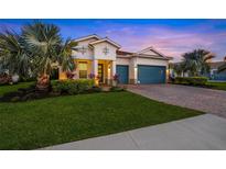 Beautiful two-story house with a three-car garage and nicely landscaped lawn at 8358 Redonda Loop, Lakewood Ranch, FL 34202
