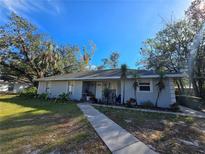 Single story home with walkway and mature landscaping at 1040 42Nd St, Sarasota, FL 34234