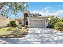 Two-story house with attached garage and landscaped lawn at 11124 Sanctuary Dr, Bradenton, FL 34209