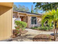 Tan colored home with walkway and landscaping at 3336 Tallywood Ct # 7084, Sarasota, FL 34237