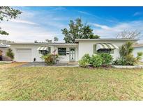 Cute ranch home with green accents and a well-maintained lawn at 3601 Yardley N Ave, St Petersburg, FL 33713