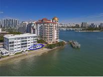 Aerial view of waterfront property with multiple buildings and a marina at 400 Golden Gate Pt # 11, Sarasota, FL 34236