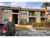 Exterior view of condo building with parking and landscaping at 4041 Crockers Lake Blvd # 24, Sarasota, FL 34238