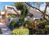 Tan colored house with lush landscaping and gated entryway at 5269 Myrtle Wood Rd # 35, Sarasota, FL 34235