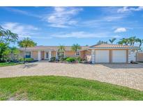 Single-story home with two-car garage, and landscaped yard at 531 N Spoonbill Dr, Sarasota, FL 34236