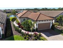 Single-story house with a tile roof and a landscaped yard at 5337 Popoli Way, Sarasota, FL 34238
