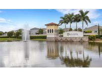 Gated community entrance with water fountain and palm trees at 5703 Tripoli Dr, Palmetto, FL 34221