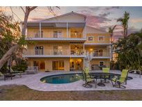 Back of house showing multi-level balconies and a pool and outdoor seating at 614 Norton St, Longboat Key, FL 34228