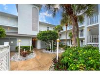 Exterior of a condo building with lush landscaping and walkway at 6304 Pointe West Blvd # A206, Bradenton, FL 34209