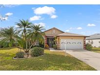 Cute one-story house with a well-manicured lawn and palm trees at 6950 42Nd E Ct, Sarasota, FL 34243