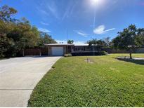 Ranch style home with attached garage, driveway and spacious lawn at 7307 9Th Nw Ave, Bradenton, FL 34209