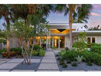 Mid-century modern home with landscaped walkway at 117 S Polk Dr, Sarasota, FL 34236