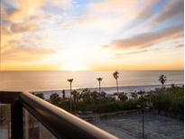 Breathtaking sunset over the ocean, beach, and tennis courts at 1281 Gulf Of Mexico Dr # 404, Longboat Key, FL 34228