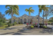 Beautiful home with palm trees and a large driveway at 13616 Legends Walk Ter, Lakewood Ranch, FL 34202