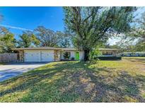 Ranch house with attached two-car garage and large yard at 1625 Bravo Dr, Clearwater, FL 33764