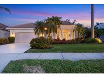 Beautiful home with landscaping, a large driveway, and a two-car garage at 2037 Silver Palm Rd, North Port, FL 34288