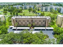 Aerial view of a condo building with parking and a golf course nearby at 3620 Ironwood Cir # 405, Bradenton, FL 34209