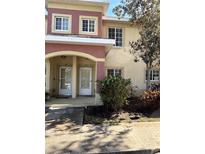 Two-story condo building with two units, featuring a shared entrance and landscaping at 3825 45Th W Ter # 104, Bradenton, FL 34210